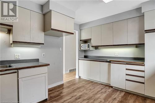 Kitchen with white cabinetry, sink, and light hardwood / wood-style flooring - 24 Crombie Street, Cambridge, ON - Indoor Photo Showing Kitchen