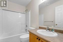 Full bathroom featuring vanity, bathtub / shower combination, and toilet - 