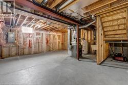 Basement with gas water heater, electric panel, and heating unit - 