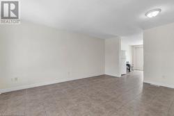 Spare room featuring light tile patterned floors and a textured ceiling - 