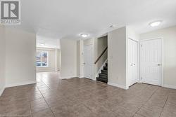 Empty room featuring light tile patterned floors and a textured ceiling - 