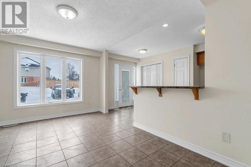 Unfurnished room featuring a textured ceiling and light tile patterned flooring - 529 Victoria Road N, Guelph, ON - Indoor