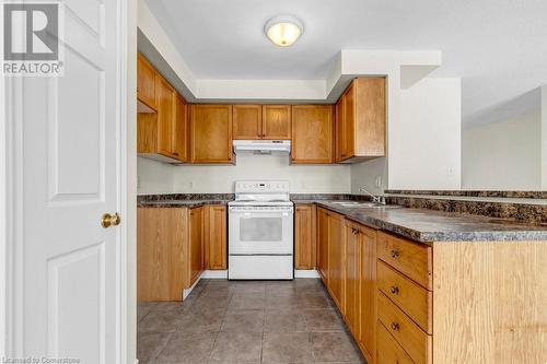 Kitchen with electric stove, sink, and light tile patterned flooring - 529 Victoria Road N, Guelph, ON - Indoor Photo Showing Kitchen