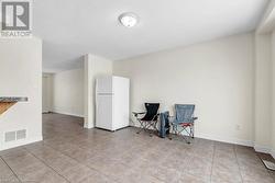 Sitting room featuring light tile patterned floors - 