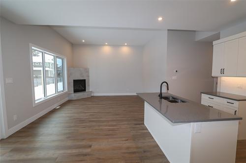 718 St. Mary River Drive, Kimberley, BC - Indoor Photo Showing Kitchen With Fireplace With Double Sink