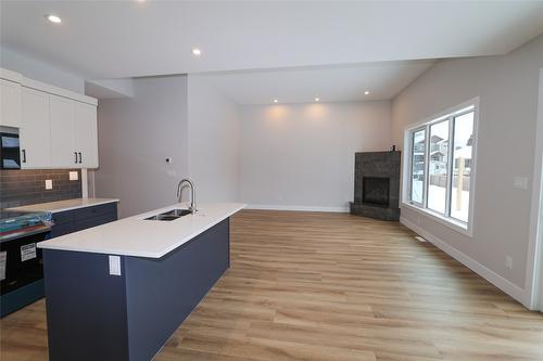 718 St. Mary River Drive, Kimberley, BC - Indoor Photo Showing Kitchen With Fireplace With Double Sink