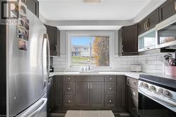 Kitchen featuring dark hardwood / wood-style flooring, stainless steel appliances, plenty of natural light, and sink - 