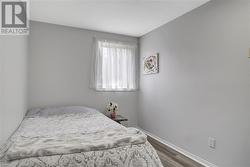 Bedroom featuring dark wood-type flooring - 