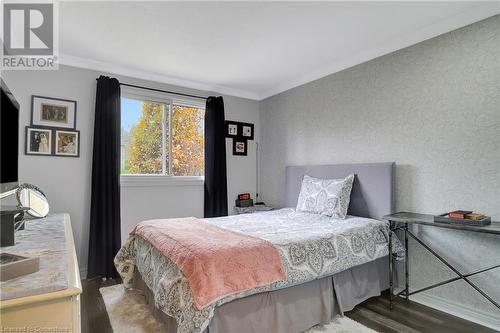 Bedroom featuring crown molding and dark hardwood / wood-style flooring - 220 Salisbury Avenue Unit# 6, Cambridge, ON - Indoor Photo Showing Bedroom