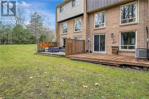 Rear view of property featuring a lawn, cooling unit, and a deck - 220 Salisbury Avenue Unit# 6, Cambridge, ON - Outdoor With Exterior