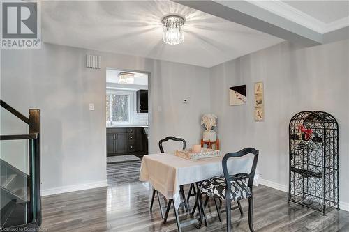 Dining space featuring a notable chandelier, dark hardwood / wood-style flooring, and crown molding - 220 Salisbury Avenue Unit# 6, Cambridge, ON - Indoor Photo Showing Dining Room