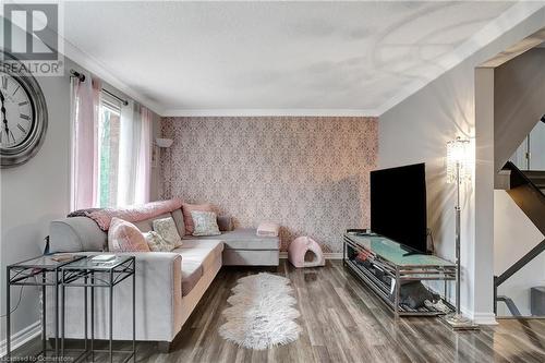 Living room featuring hardwood / wood-style floors, a textured ceiling, and ornamental molding - 220 Salisbury Avenue Unit# 6, Cambridge, ON - Indoor Photo Showing Living Room