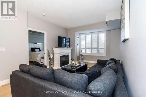 718 - 16 Dallimore Circle, Toronto, ON - Indoor Photo Showing Living Room With Fireplace