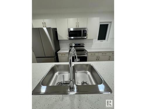 #115 1025 Secord Promenade Nw Nw, Edmonton, AB - Indoor Photo Showing Kitchen With Double Sink