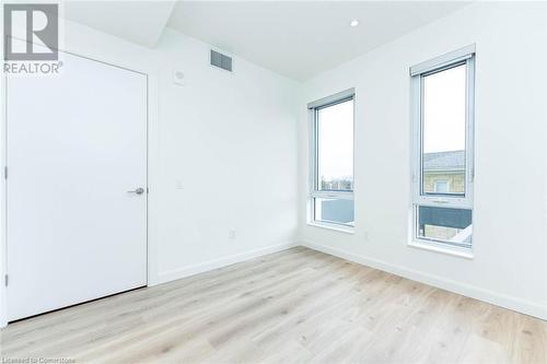 Bedroom with luxury laminate floors and potlights - 741 King Street W Unit# 301, Kitchener, ON - Indoor Photo Showing Other Room