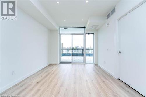 Living room with sliding doors and walk-out to your large private terrace - 741 King Street W Unit# 301, Kitchener, ON - Indoor Photo Showing Other Room