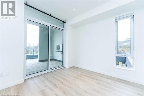 Bedroom 2 featuring a healthy amount of sunlight and sliding doors with walk-out to the private terrace - 741 King Street W Unit# 301, Kitchener, ON - Indoor Photo Showing Other Room