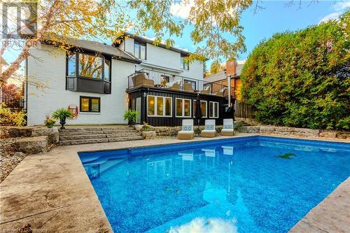 Rear view of house featuring a balcony - 659 Deervalley Road, Ancaster, ON - Outdoor With In Ground Pool With Deck Patio Veranda