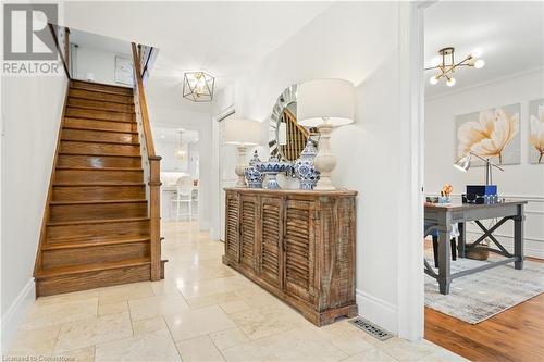 Foyer entrance featuring a notable chandelier, ornamental molding, and light hardwood / wood-style flooring - 659 Deervalley Road, Ancaster, ON - Indoor Photo Showing Other Room