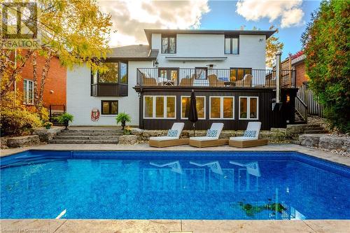 Rear view of property featuring a balcony - 659 Deervalley Road, Ancaster, ON - Outdoor With In Ground Pool With Deck Patio Veranda