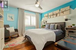 Bedroom featuring ceiling fan and dark hardwood / wood-style floors - 