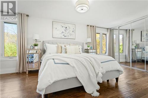 Bedroom featuring multiple windows, a closet, and dark hardwood / wood-style floors - 659 Deervalley Road, Ancaster, ON - Indoor Photo Showing Bedroom