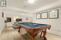 Playroom with light hardwood / wood-style floors and pool table - 