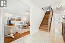 Stairs featuring hardwood / wood-style flooring and an inviting chandelier - 659 Deervalley Road, Ancaster, ON  - Indoor 