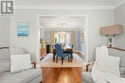 Dining space featuring hardwood / wood-style flooring, crown molding, and a notable chandelier - 