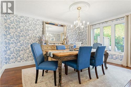 Dining space with crown molding, light hardwood / wood-style floors, and an inviting chandelier - 659 Deervalley Road, Ancaster, ON - Indoor Photo Showing Dining Room