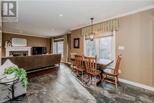 Dining room featuring crown molding, a high end fireplace, and an inviting chandelier - 17 Weir Drive, Guelph, ON - Indoor With Fireplace