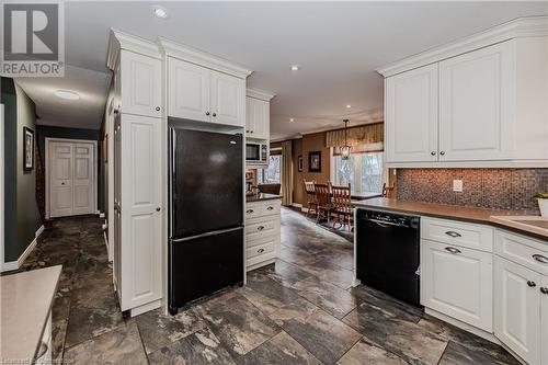 Kitchen featuring backsplash, pendant lighting, white cabinets, and black appliances - 17 Weir Drive, Guelph, ON - Indoor Photo Showing Kitchen