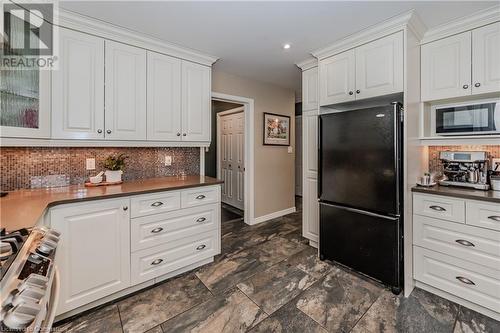 Kitchen featuring black refrigerator, stove, backsplash, and white cabinetry - 17 Weir Drive, Guelph, ON - Indoor Photo Showing Kitchen