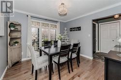 Dining space with a textured ceiling, a notable chandelier, light hardwood / wood-style floors, and crown molding - 