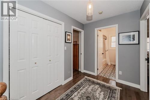 Corridor with a textured ceiling and dark hardwood / wood-style floors - 17 Weir Drive, Guelph, ON - Indoor