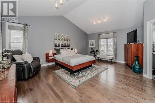 Bedroom with track lighting, vaulted ceiling, and hardwood / wood-style flooring - 17 Weir Drive, Guelph, ON - Indoor Photo Showing Bedroom