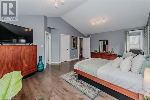 Bedroom featuring hardwood / wood-style flooring, track lighting, and vaulted ceiling - 17 Weir Drive, Guelph, ON - Indoor Photo Showing Bedroom