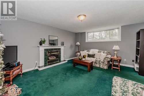 Carpeted living room with a tiled fireplace - 17 Weir Drive, Guelph, ON - Indoor Photo Showing Living Room With Fireplace