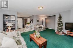 Carpeted living room featuring a textured ceiling - 