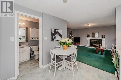 Dining space with a textured ceiling, sink, and a tile fireplace - 17 Weir Drive, Guelph, ON - Indoor With Fireplace