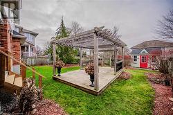 View of yard with an outbuilding, a pergola, and a wooden deck - 