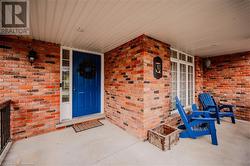 Doorway to property with covered porch - 