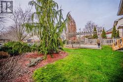 View of yard featuring a pergola and a wooden deck - 