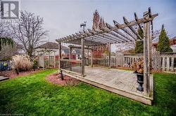 View of yard featuring a deck and a pergola - 