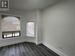 Empty room featuring dark wood-type flooring - 