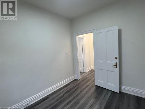 Spare room featuring dark hardwood / wood-style floors - 660 Main Street E Unit# 1, Hamilton, ON - Indoor Photo Showing Other Room