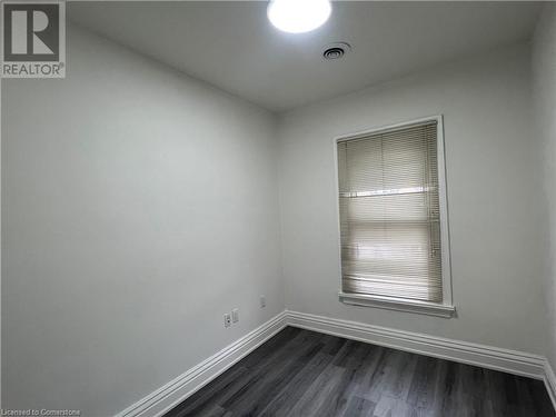 Spare room featuring dark hardwood / wood-style floors - 660 Main Street E Unit# 1, Hamilton, ON - Indoor Photo Showing Other Room