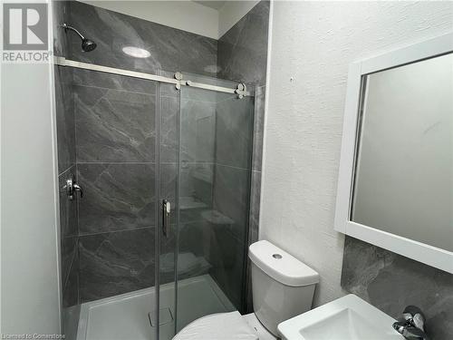 Bathroom with toilet, an enclosed shower, and sink - 660 Main Street E Unit# 1, Hamilton, ON - Indoor Photo Showing Bathroom