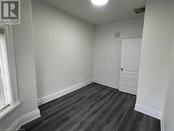 Spare room with dark wood-type flooring - 