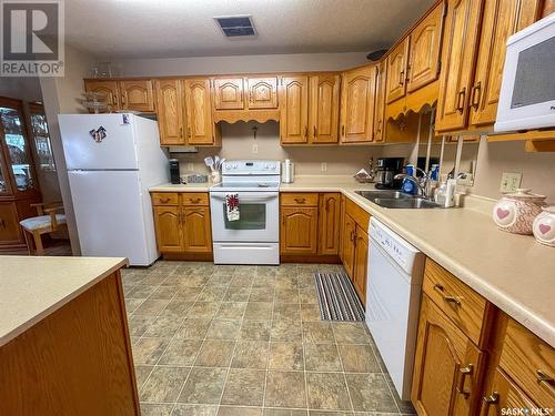 301 119 4Th Avenue W, Kindersley, SK - Indoor Photo Showing Kitchen With Double Sink